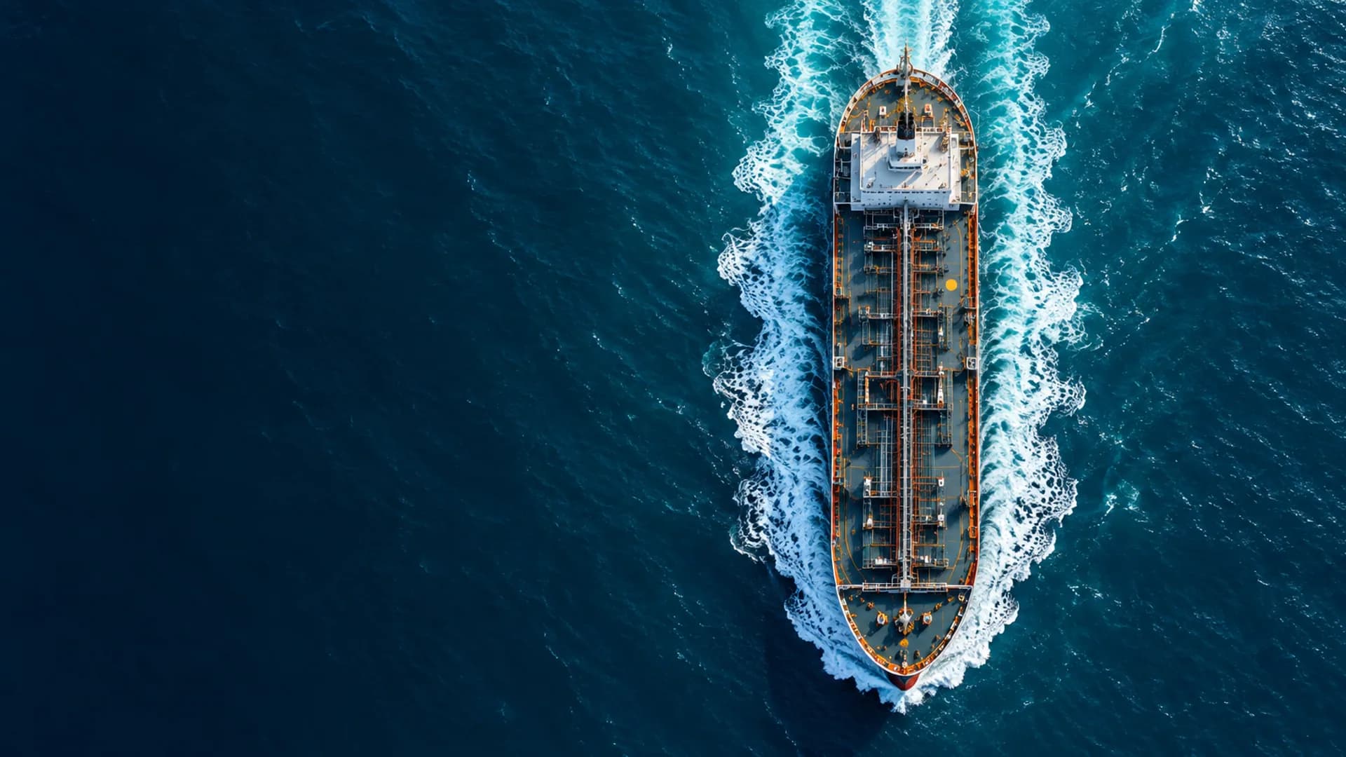 Cargo vessel crossing deep blue ocean water
